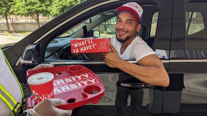 Atlanta resident Jake Major is the first customer at the Varsity's new drive-thru. The iconic Midtown restaurant suspended carhop service earlier this year due to the pandemic.  / Varsity Facebook page