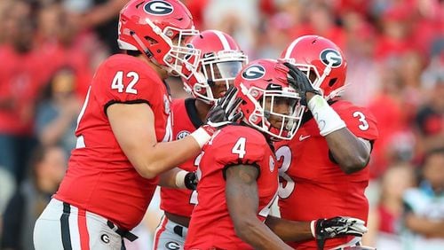 Georgia special teams players celebrate with Mecole Hardman after he downed South Carolina inside the 5-yard line on a punt during the second half at Sanford Stadium in Athens, Ga., on Saturday, Nov. 4, 2017. The host Bulldogs won, 24-10. (Curtis Compton/Atlanta Journal-Constitution/TNS)