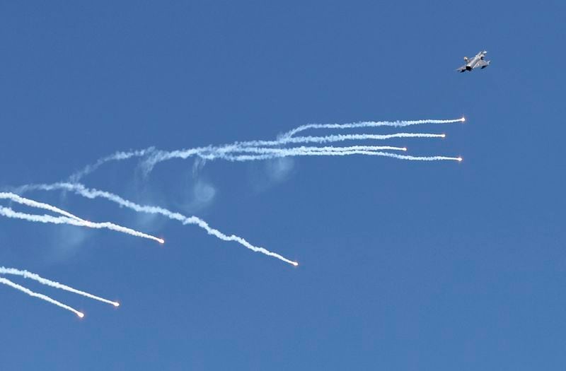 FILE - An Israeli-made fighter jet releases flares during a tribute ceremony, in Bogota, Colombia, Jan. 27, 2021. (AP Photo/Fernando Vergara, File)