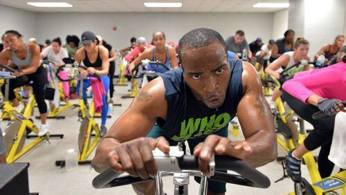 Keith Thompson leads his indoor-cycling class at the Adamsville Recreation Center on Friday, April 4, 2014. At 280 lbs, Keith Thompson wasn’t satisfied with his weight or his health. So, starting with step classes at a local gym, he dedicated his life to fitness and lost over 70 lbs. Several years later, fellow step classmates - who had long since noticed Keith’s contagious energy and positive attitude - suggested that he’d find success as an instructor. HYOSUB SHIN / HSHIN@AJC.COM