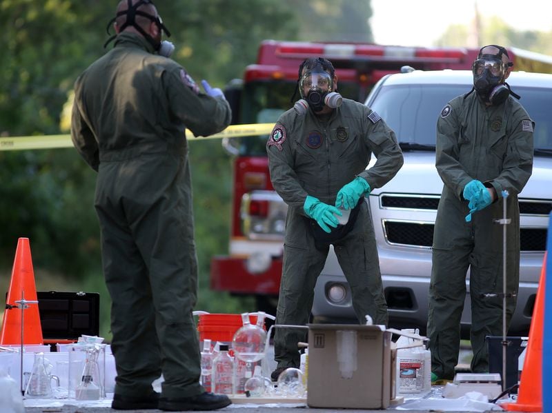June 19, 2013 Avondale Estates: DEA agents help clean up a synthetic drug lab that was found in a house on Rockbridge Road in Avondale Estates on Wednesday afternoon June 19, 2013. BEN GRAY / BGRAY@AJC.COM