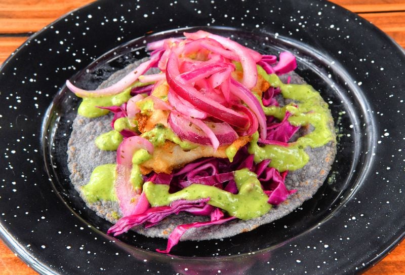 The pescado taco from Antiguo Lobo features breaded mahi-mahi, and is a standout among the tacos on the menu. (Chris Hunt for The Atlanta Journal-Constitution)