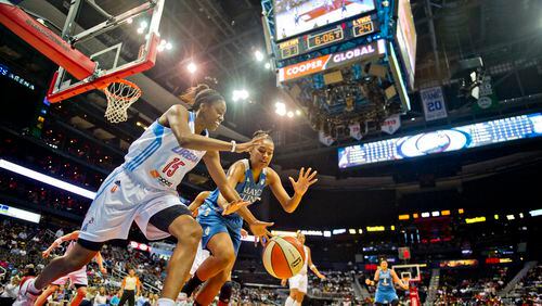 Atlanta's Tiffany Hayes (15) anf Minnesota's Damiris Dantas (right) chase after a loose ball during their game at Philips Arena in Atlanta on Friday, June 13, 2014.