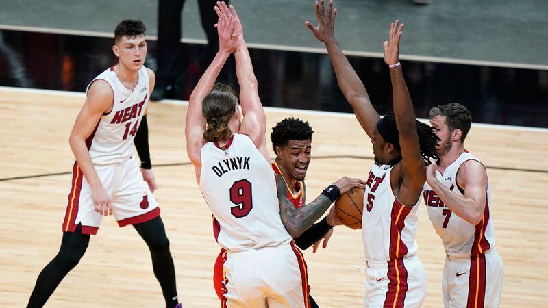 Atlanta Hawks forward John Collins (center) looks for an opening past Miami Heat's Tyler Herro (from left), Kelly Olynyk, Precious Achiuwa and Goran Dragic during the first half Tuesday, March 2, 2021, in Miami. (Wilfredo Lee/AP)