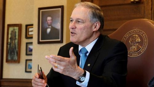 Washington Gov. Jay Inslee speaks during a morning meeting with staff members in his office, Wednesday, Feb. 27, 2019, at the Capitol in Olympia, Wash. (AP Photo/Ted S. Warren)