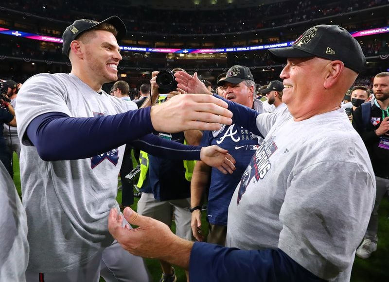 Freddie Freeman and manager Brian Snitker find each other in the midst of the celebration and embrace after beating the Astros in game 6 to win the World Series on Tuesday, Nov. 2, 2021, in Houston.   “Curtis Compton / Curtis.Compton@ajc.com”