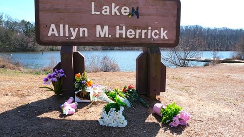 A sign at Lake Herrick has been altered to honor Laken Riley, who was killed Feb. 22 on the running trails behind the lake in Athens. The arrest of the suspect in her death, a man authorities say illegally entered the U.S. in 2022, has fed a surge of legislation in the Georgia General Assembly targeting illegal immigration and strengthened border security's position as a top issue in November's elections. (Nell Carroll for The Atlanta Journal-Constitution)