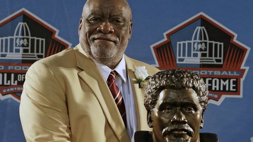 Hall of Fame Inductee Claude Humphrey poses with his bust during the 2014 Pro Football Hall of Fame Enshrinement Ceremony at the Pro Football Hall of Fame Saturday, Aug. 2, 2014, in Canton, Ohio. (AP Photo/Tony Dejak)