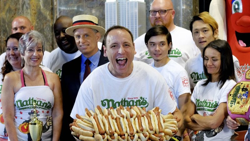Ten-time and defending Nathan's Famous Men's Champion Joey Chestnut poses with 72 hot dogs during Nathan's Famous International Fourth of July Hot Dog Eating Contest weigh-in at the Empire State Building on Tuesday, July 3, 2018, in New York.