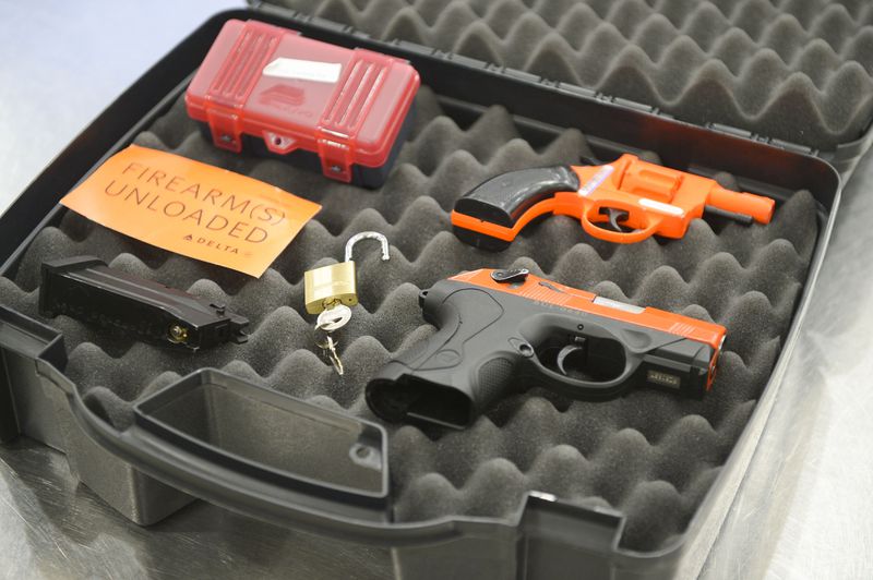 A hard-sided case, locks, handguns, and firearms declaration cards are seen Wednesday, April 6, 2022 at Hartsfield-Jackson International Airport. These items are needed to properly transport firearms on flights.  (Daniel Varnado/For the Atlanta Journal-Constitution)
