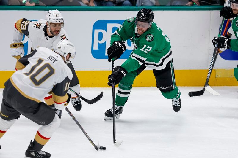 Dallas Stars center Radek Faksa (12) competes for the puck against Vegas Golden Knights center Nicolas Roy (10) and defenseman Alec Martinez (23) during the third period in Game 7 of an NHL hockey Stanley Cup first-round playoff series, Sunday, May 5, 2024, in Dallas. (AP Photo/Brandon Wade)