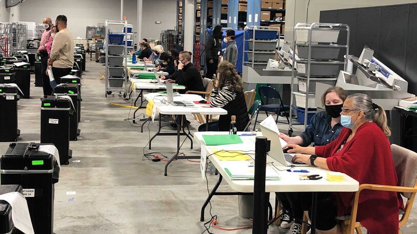 Workers entering recounted votes into Gwinnett County’s database began working in teams of two at each station. (Photo: Christopher Quinn/AJC)