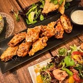 Wings, empanadas and grilled octopus with mixed greens are among the options at Marietta Proper. Henri Hollis/henri.hollis@ajc.com