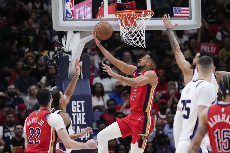 New Orleans Pelicans guard CJ McCollum (3) goes to the basket in the first half of an NBA basketball play-in tournament game against the Sacramento Kings in New Orleans, Friday, April 19, 2024. (AP Photo/Gerald Herbert)