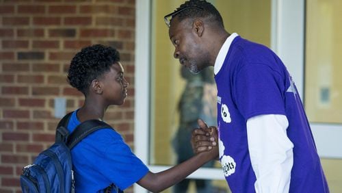 Peachcrest Elementary School assistant principal Stan Gaddis engages with a student on the first day of school in Decatur, Monday, August 6, 2018. (ALYSSA POINTER/ALYSSA.POINTER@AJC.COM)