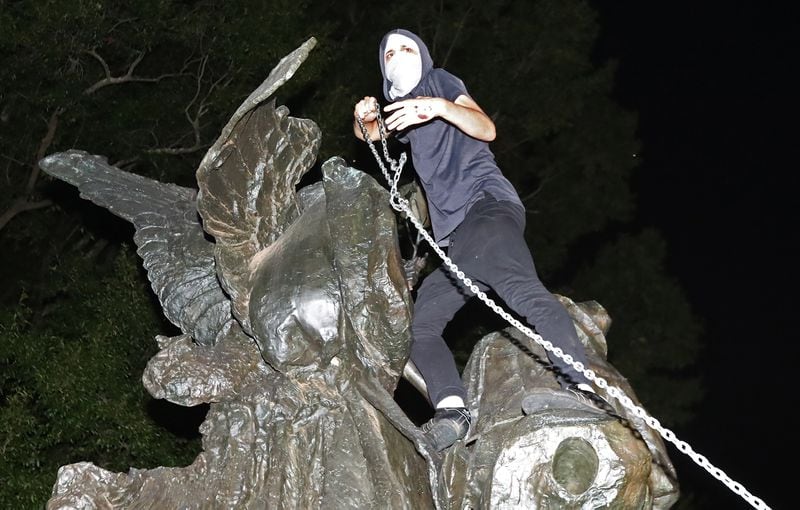  Protesters tried tearing down the Peace Monument on Sunday night. AJC photo: Curtis Compton