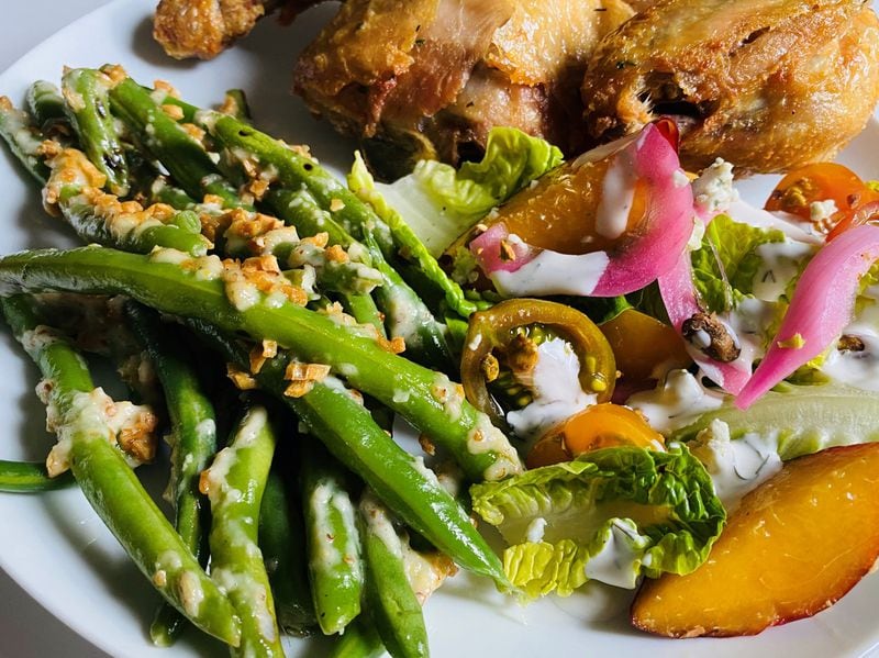 Wonderkid’s half a roasted chicken is served here with garlic green beans and a Little Gem salad. CONTRIBUTED BY BOB TOWNSEND