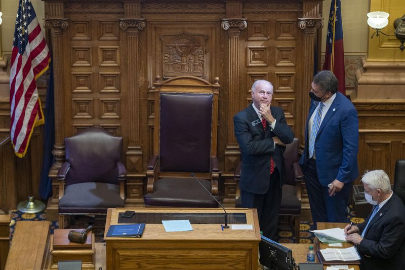 Republican state Sen. Steve Gooch of Dahlonega, right, speaks with Senate President Pro Tem Butch Miller, R-Gainesville, as Miller presides over the Senate during a debate at the Georgia Capitol. Miller took the gavel after Lt. Gov. Geoff Duncan excused himself from the debate because he opposed rolling back absentee voting in Georgia. (Alyssa Pointer / Alyssa.Pointer@ajc.com)