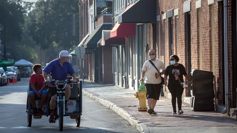 SAVANNAH, GA - Sept. 2, 2020: A couple visiting from Atlanta choose to wear masks while walking in historic downtown Savannah. (AJC Photo/Stephen B. Morton)