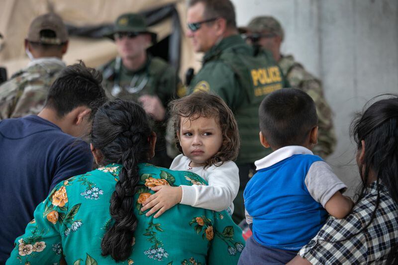 MCALLEN, TEXAS - JULY 02: Immigrants wait to be interviewed by U.S. Border Patrol agents after they were taken into custody on July 02, 2019 in McAllen, Texas. (Photo by John Moore/Getty Images)