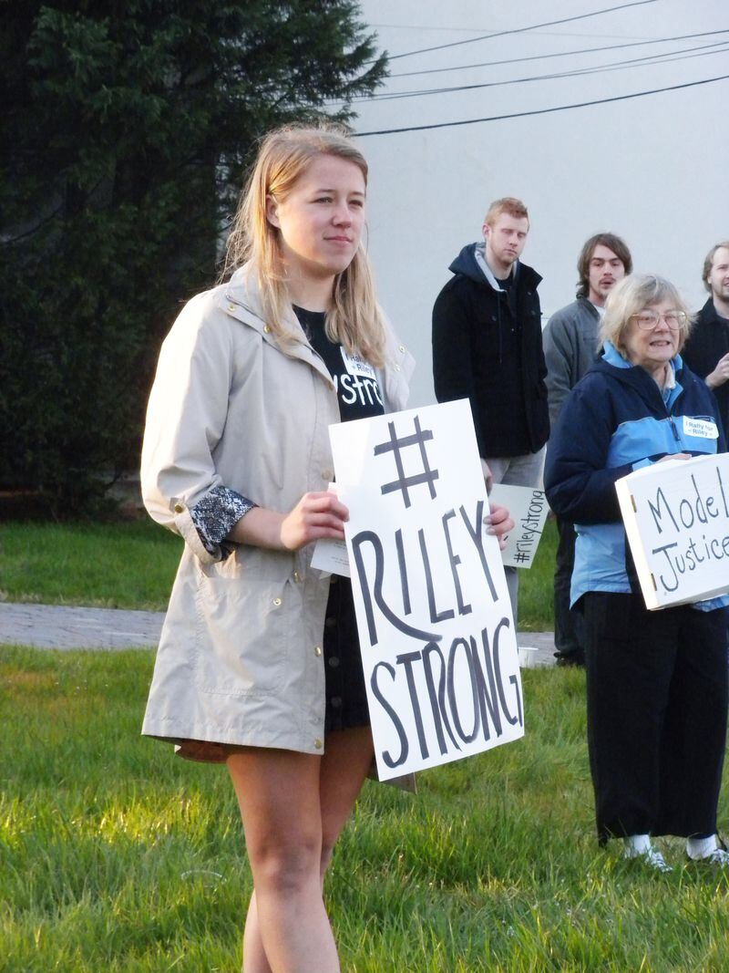 Sarah Stubbs, one of the Decatur High grads who organized a rally for fired clerk Susan Riley, hold a sign at the event last week. (Duo-Wei Yang)