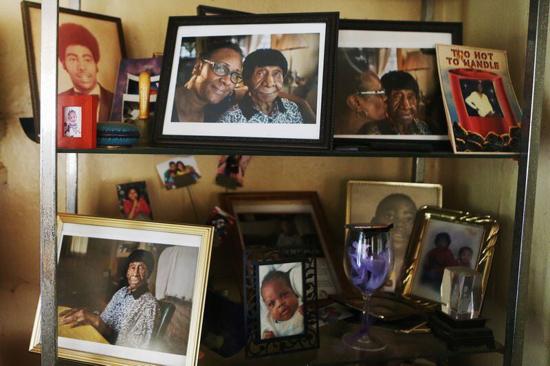 Photos of Willie Mae Hardy and her family displayed on a shelf in Decatur, Georgia on Thursday, July 18, 2019. At 111 years old, Hardy is the oldest living African-American in the United States. Hardy was born in 1908 in Junction City, Georgia, and was the granddaughter of a slave. She moved to Atlanta in 1939 looking for a better life for her and her late daughter, Cassie, and has lived in the city ever since. Veronica Edwards, Hardy's granddaughter, is the primary caregiver for Hardy. Hardy had the opportunity to meet former First Lady Michelle Obama during Obama's book tour in May.