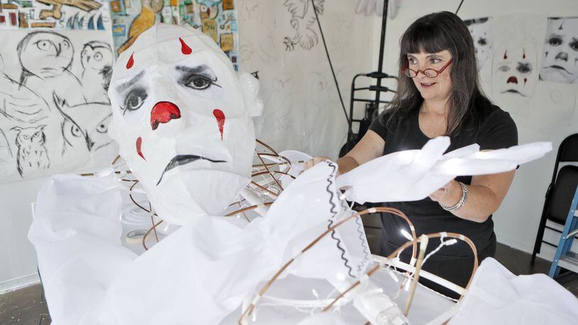 Chantelle Rytter works on one of her super-sized street puppets, this one a replica of Puddles Pity Party, the singing clown, in her Midtown studio. BOB ANDRES /BANDRES@AJC.COM