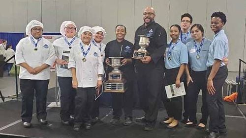 Meadowcreek High School Culinary and Management teams stand with Chef Tanisha Mott Tucker, center left, and Chef Jay Richardson, center right. COURTESY OF GWINNETT COUNTY PUBLIC SCHOOLS
