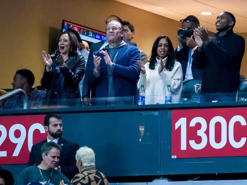 Vice President Kamala Harris (left), an alum of Howard University, celebrates with her husband, Douglas Emhoff (standing next to her) after Howard scores a touchdown at the Celebration Bowl, Howard University versus Florida A&M, at Mercedes Benz Stadium in Atlanta, Georgia on December 16, 2023. (Jamie Spaar for the Atlanta Journal Constitution)