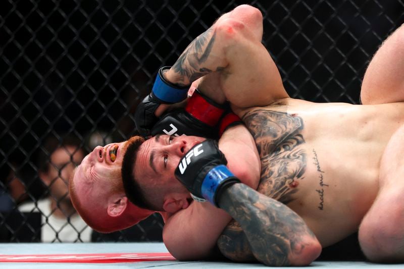 Bo Nickal has Cody Brundage in a chokehold during a UFC 300 mixed martial arts middleweight bout Saturday, April 13, 2024, in Las Vegas. (Ellen Schmidt/Las Vegas Review-Journal via AP)