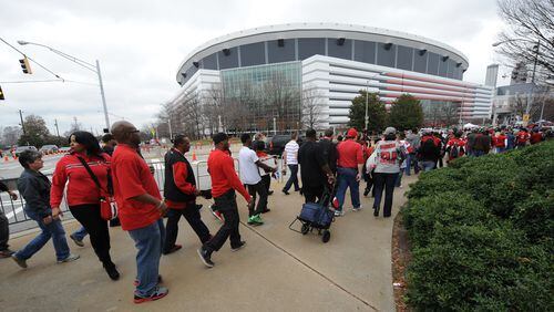Atlanta Falcon fans walk from the Vine City Marta Station to the Atlanta Falcons NFC playoff game against the Seattle Seahawks in the Georgia Dome on Sunday, January 13, 2012. JOHNNY CRAWFORD / JCRAWFORD@AJC.COM
