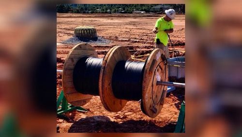 Workers at Avalon, a massive mixed-use development in Alpharetta, recently laid fiber optic cable that will connect every residence, retail shop, office space and hotel with “gigabit” Internet service that is many times faster than traditional broadband service.