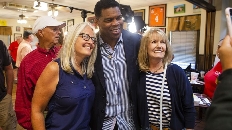 Herschel Walker (middle) takes a photo with Jan Smythe (right) and another woman (left), during a meet and greet event on Wednesday, July 27, 2022, at Longstreet Cafe in Gainesville, Georgia. Fox & Friends broadcasted live from the restaurant during which co-host Brian Kilmeade interviewed Walker. CHRISTINA MATACOTTA FOR THE ATLANTA JOURNAL-CONSTITUTION.