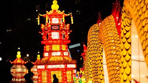 A man is silhouetted against the Chinese Palace lantern at the Chinese Lantern Festival in Centennial Olympic Park, Friday, Dec. 9, 2016, in Atlanta. Branden Camp/Special