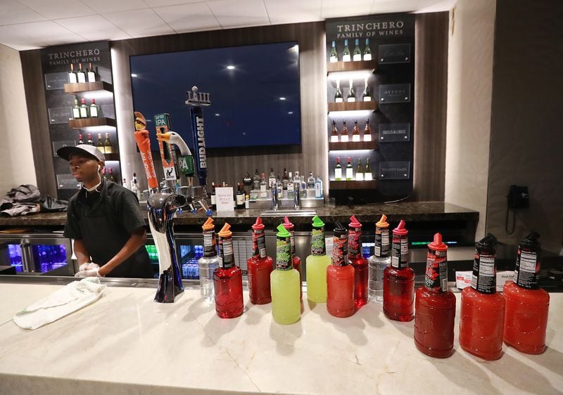 An employee prepares the stock in the bar at the Delta Sky360 Club for the Super Bowl inside Mercedes-Benz Stadium on Tuesday, Jan. 22, 2019, in Atlanta. (Curtis Compton/ccompton@ajc.com)