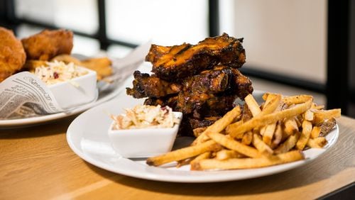 Howell's Kitchen and Bar Peach-Smoked Baby Back Ribs with house barbacue sauce, hand-cut fries, and cabbage slaw. Photo credit- Mia Yakel.