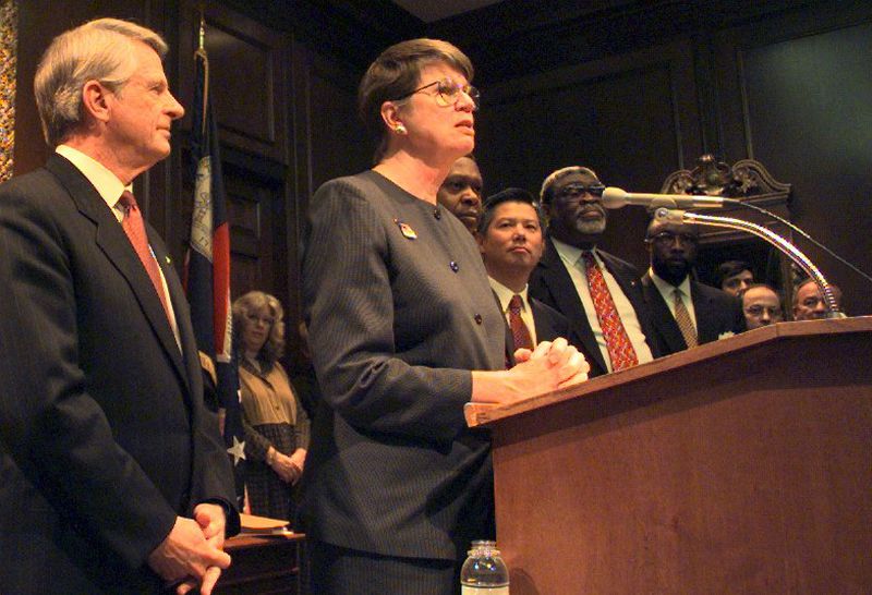 Georgia Gov. Zell Miller stands by as U.S. Attorney General Janet Reno speaks in 1998 about a consent agreement to improve dangerous conditions in the state's juvenile justice system. AJC FILES