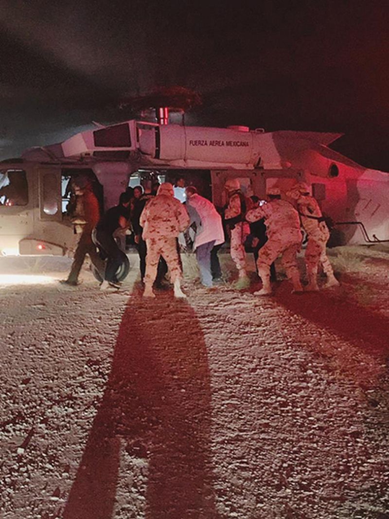 In this photo provided by the Sonora state health secretary, children of the extended LeBaron family, who were injured in an ambush, are taken aboard a Mexican Airforce helicopter to be flown to the Mexico-U.S. border.