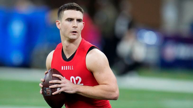 Georgia quarterback Stetson Bennett warms up before he runs a drill at the NFL football scouting combine in Indianapolis, Saturday, March 4, 2023. (AP Photo/Michael Conroy)