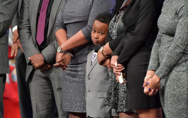 Bishop Eddie Long’s grandson Eric II stands as family members give tributes during the homegoing services for Long, senior pastor at New Birth Missionary Baptist Church in Lithonia, on Wednesday, Jan. 25, 2017. Long died Jan. 15 at age 63. HYOSUB SHIN / HSHIN@AJC.COM