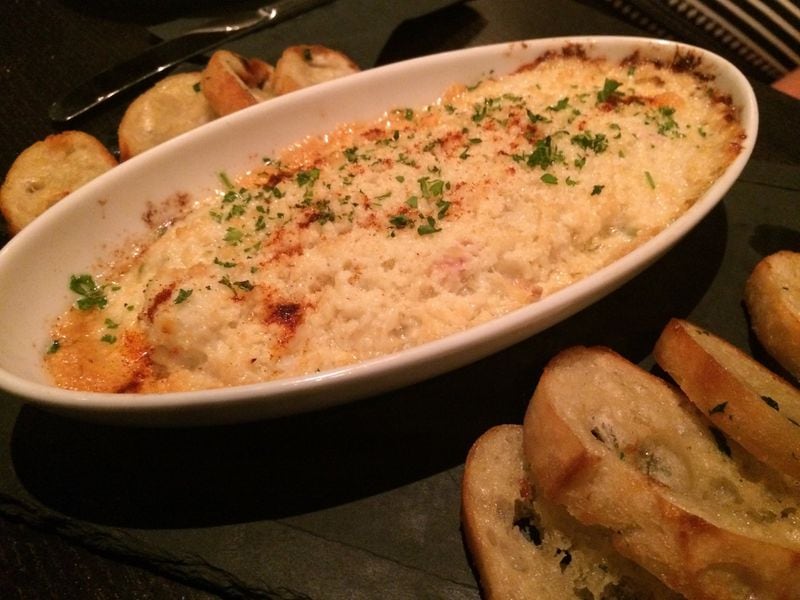 The crab dip at Simon’s Restaurant is a hot and cheesy gratin, meant to be spread on buttery slices of baguette. CONTRIBUTED BY WENDELL BROCK