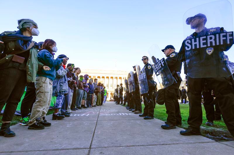 Protesters against the war in Gaza confront law enforcement personnel during demonstrations on the campus of UW-Madison in Madison, Wis. on Wednesday, May 1, 2024. (John Hart/Wisconsin State Journal via AP)