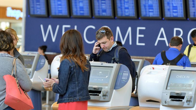 Travelers check in at Delta's self-check-in kiosks at Hartsfield-Jackson International Airport.