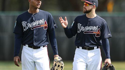 Ender Inciarte gives Cristian Pache some tips in right field.