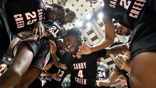 Sandy Creek players celebrate their victory over Cedar Grove during 2023 GHSA Basketball Class 3A Boy’s State Championship game at the Macon Centreplex, Friday, March 10, 2023, in Macon, GA. Sandy Creek won 66-38 over Cedar Grove. (Hyosub Shin / Hyosub.Shin@ajc.com)