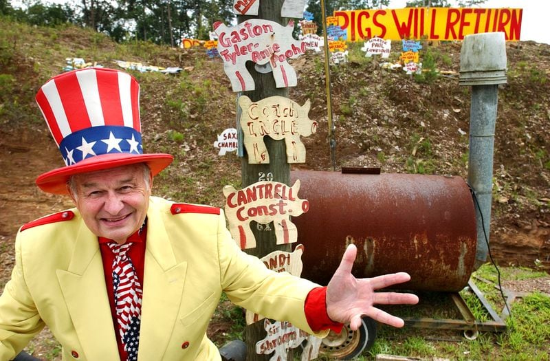 The late Oscar Poole, owner of Col. Poole's Bar-B-Q in Ellijay, stands outside his Ellijay eatery in 2003. Poole died in 2020 at age 90. (AJC file photo)