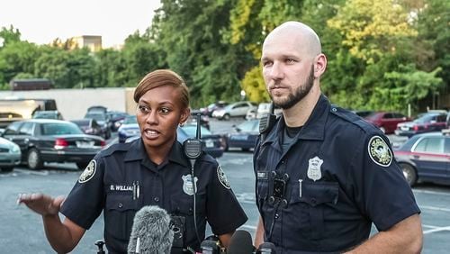 Officers Brittany Williams and Charles Tierney helped pull a man from a burning vehicle in Buckhead on Sunday morning. The man was not burned and no officers were injured.
