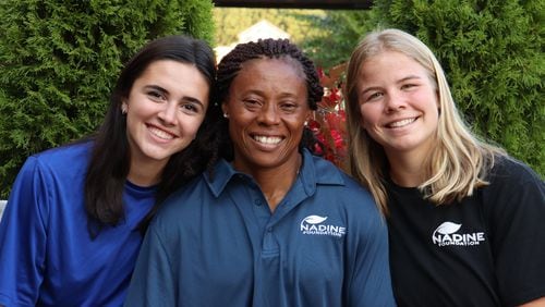 Coach Nadine Kezebou (center) with her soccer players Marilee Karinshak (left) and Molly Pritchard (right). The Gwinnett teenagers helped Kezebou fundraise for a new elementary school in Cameroon. (Tyler Wilkins / tyler.wilkins@ajc.com)