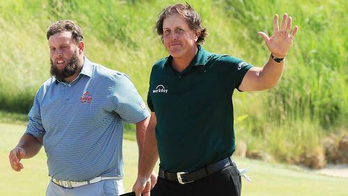 Andrew 'Beef' Johnston of England (L) and Phil Mickelson of the United States acknowledge the crowd on the 18th green during the third round of the 2018 U.S. Open at Shinnecock Hills Golf Club on June 16, 2018 in Southampton, New York. (Photo by Andrew Redington/Getty Images)