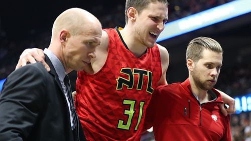 Hawks’ Mike Muscala grimaces with an apparent injury against the Bucks in the first half of a NBA basketball game on Sunday, Jan. 15, 2017, in Atlanta. Muscala left the game and did not return. Curtis Compton/ccompton@ajc.com